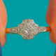 Art Deco Diamond cluster ring, front view of the shaped Platinum face and Diamond shoulders