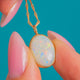 Oval Opal necklace, front view of the cabochon and Gold rim