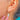 Close worn view of an Opal pear-drop earring