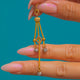 Französischer Anhänger aus 18 Karat Gold mit Diamant-Trio und Quaste